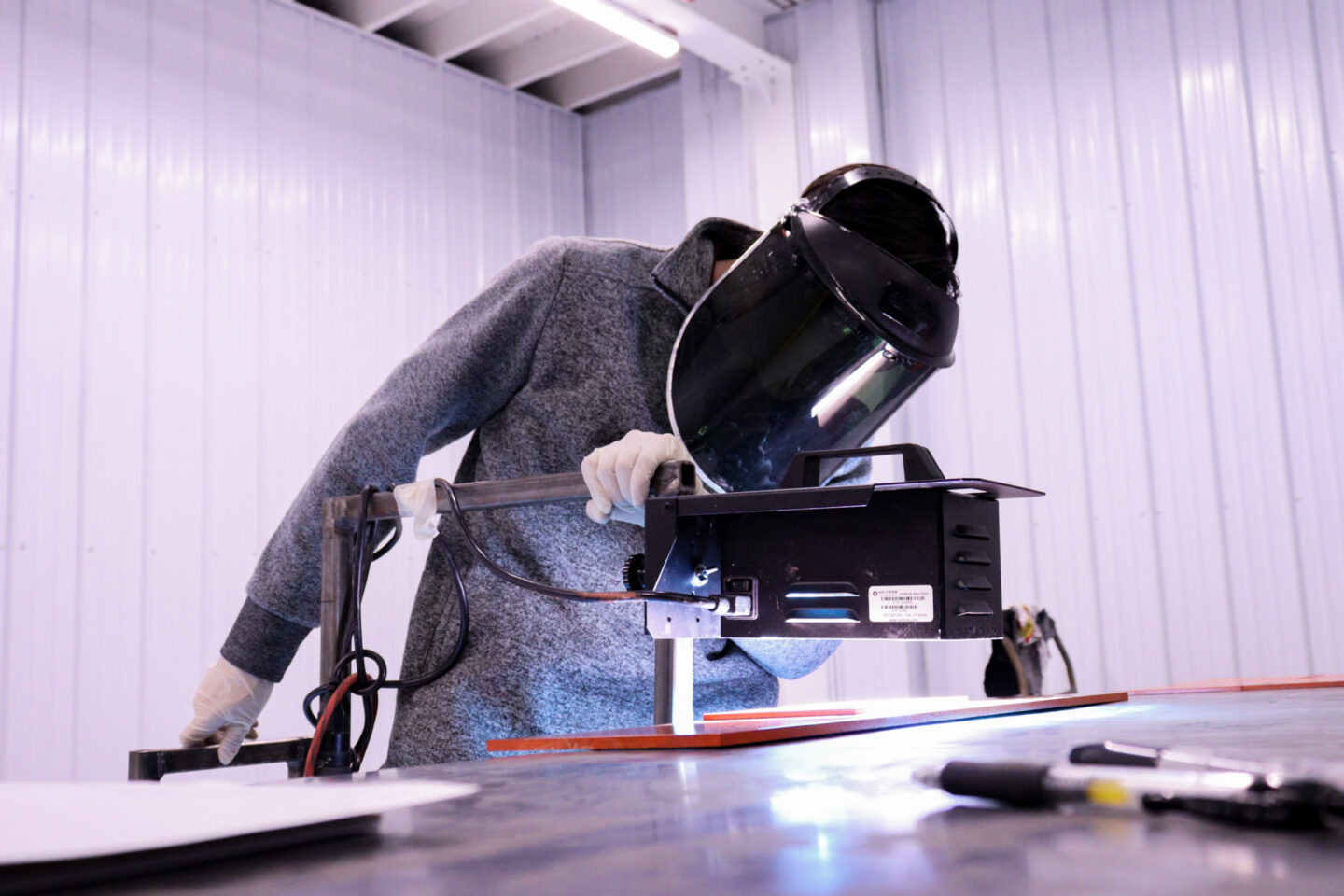 UV lamp curing a part that has orange color dielectric coating.